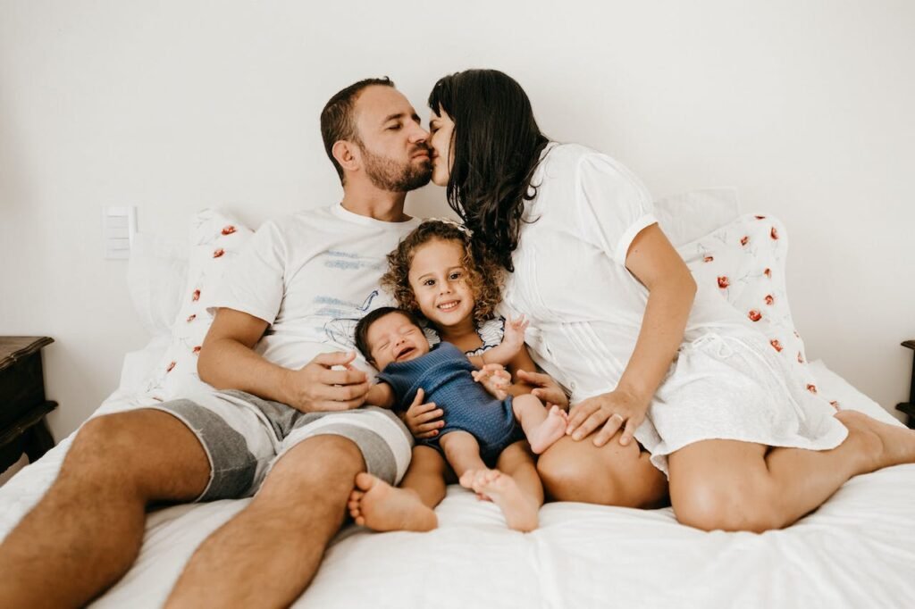 Parents kissing with two children