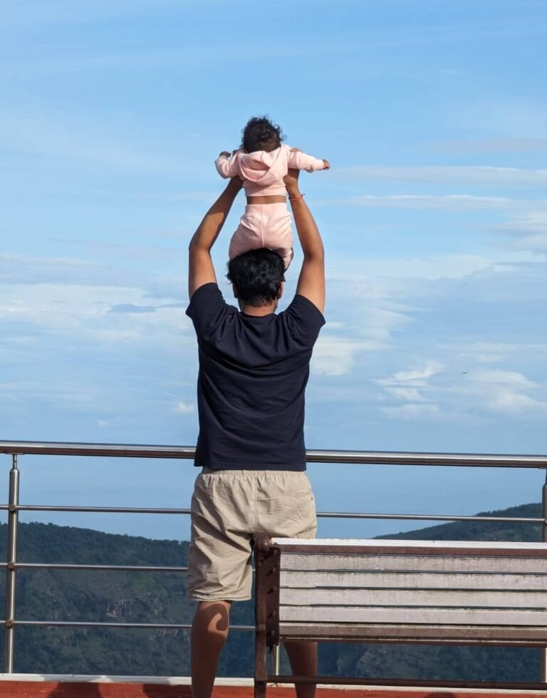 Man holding his baby in the air