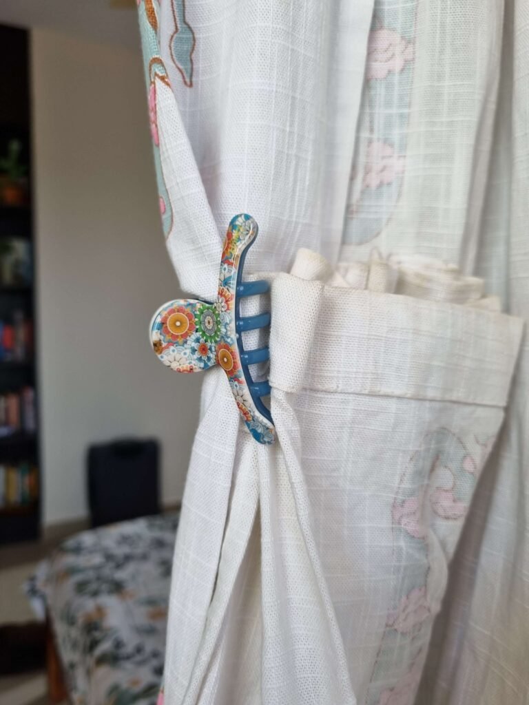 Hair clip holding up a curtain