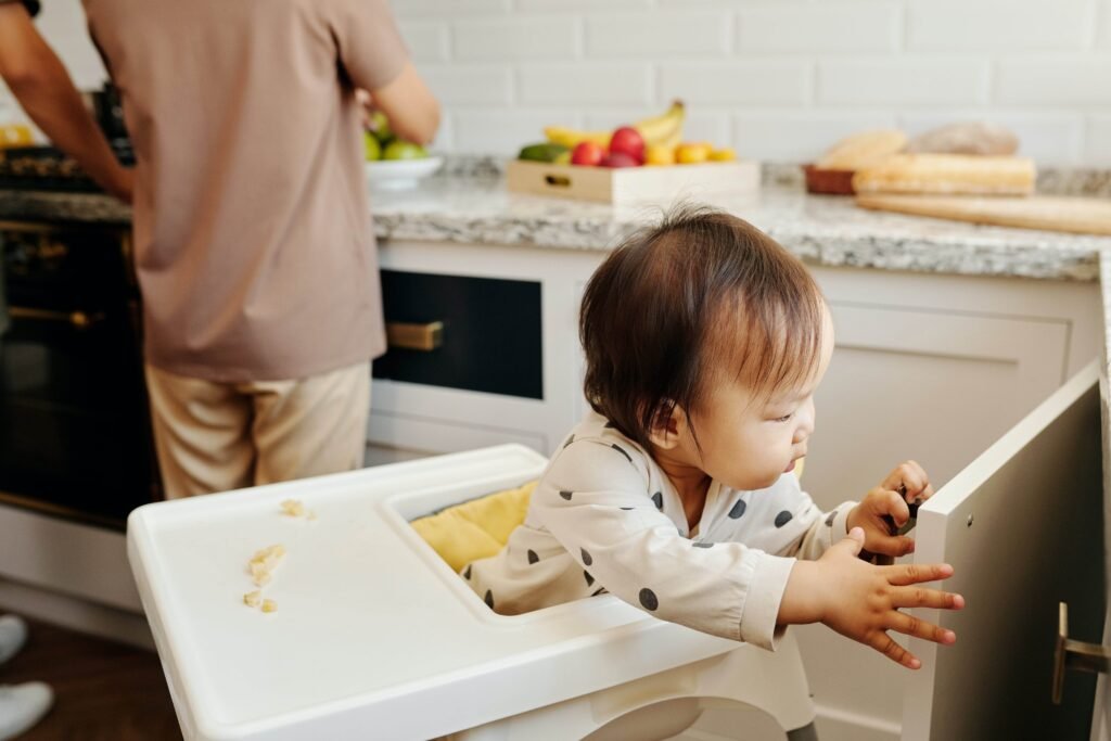 Image of a child in high chair in the kitchen