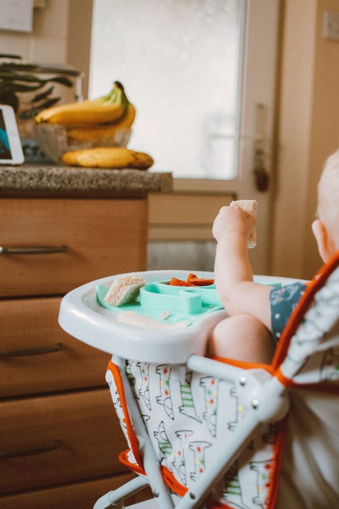 baby in high chair during baby led weaning