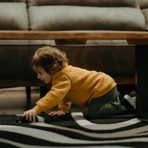 Child playing on the floor near a coffee table