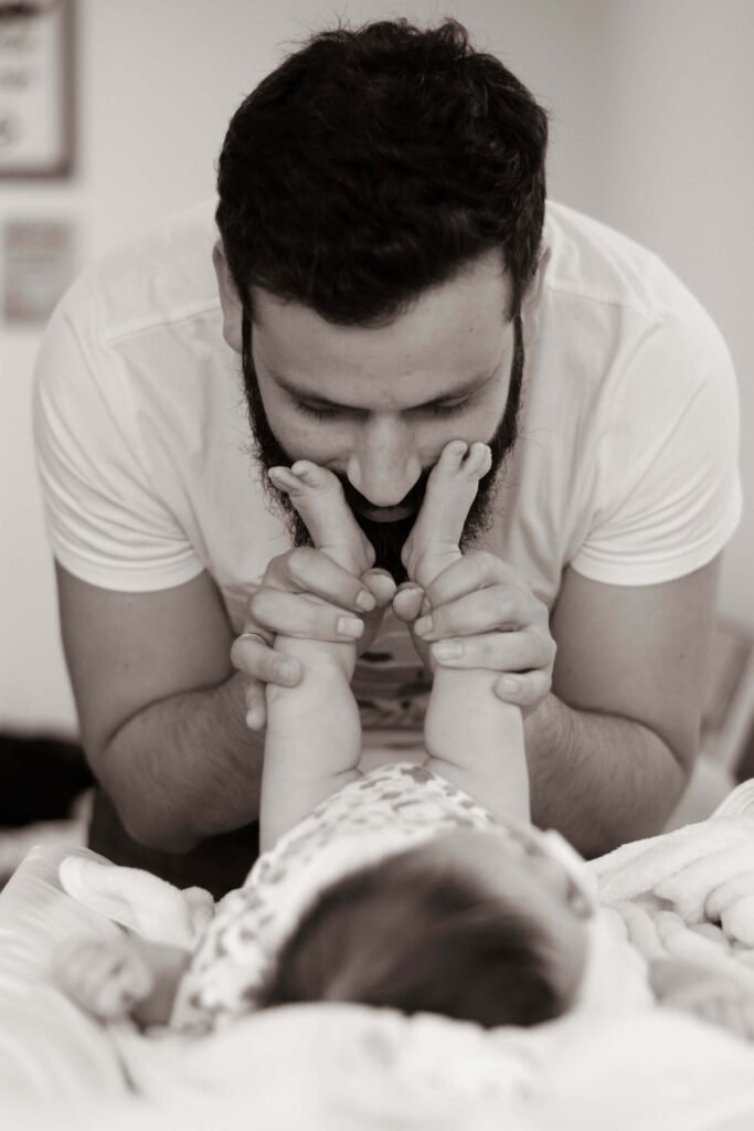 Dad newborn bonding through massage