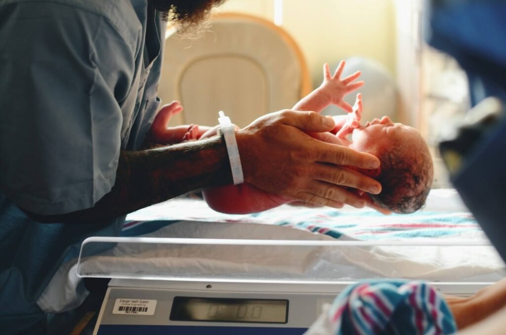 Newborn being weighed after birth