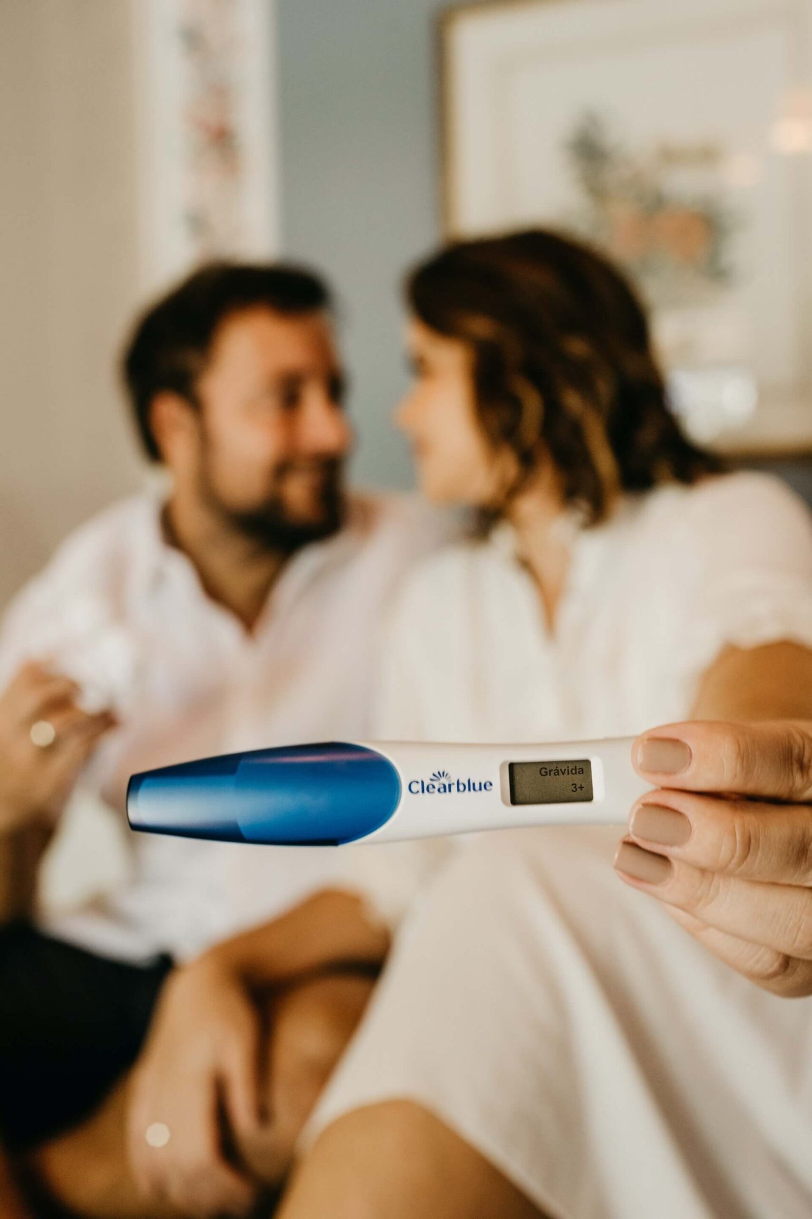 A couple showing positive pregnancy stick result