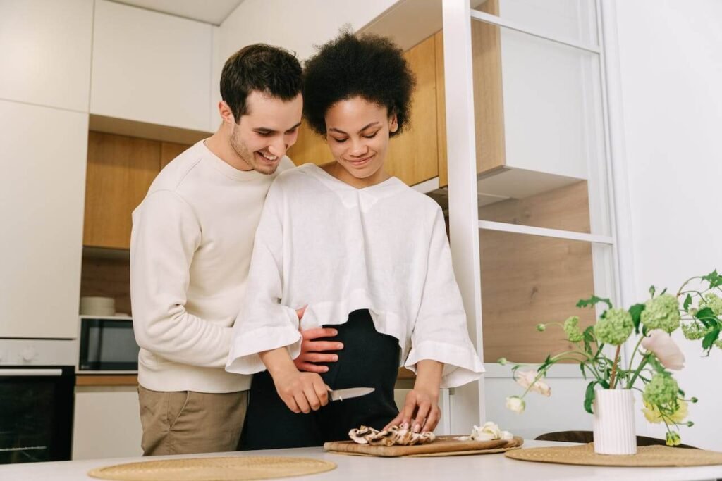 Pregnant woman and her partner cooking