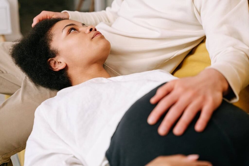 Pregnant woman resting on her partner