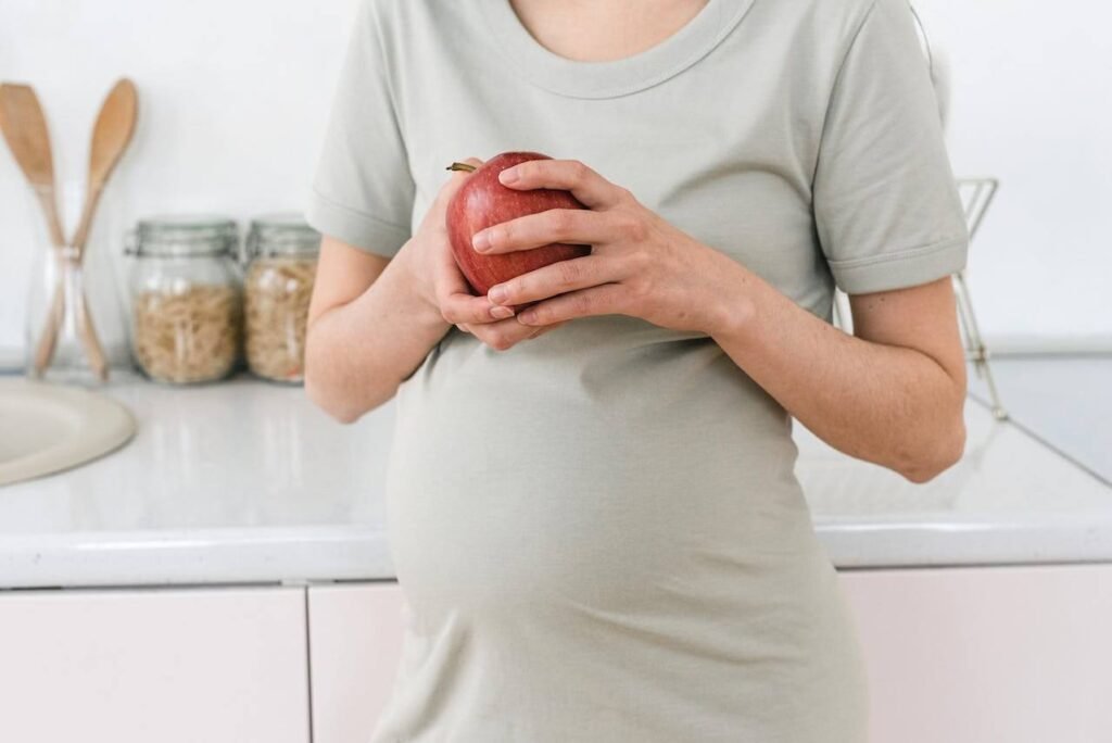 Pregnant woman eating an apple