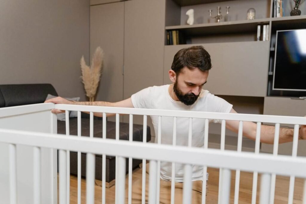 Dad setting up the baby crib